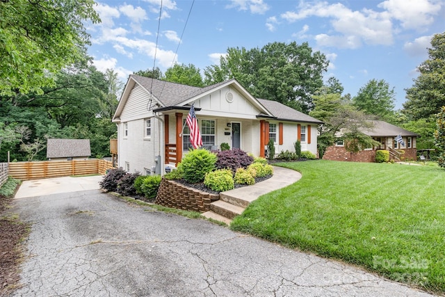1621 Brookdale Ave, Charlotte, NC 28210 - view of front of home with covered porch, brick siding, driveway, board and batten siding, and roof with shingles