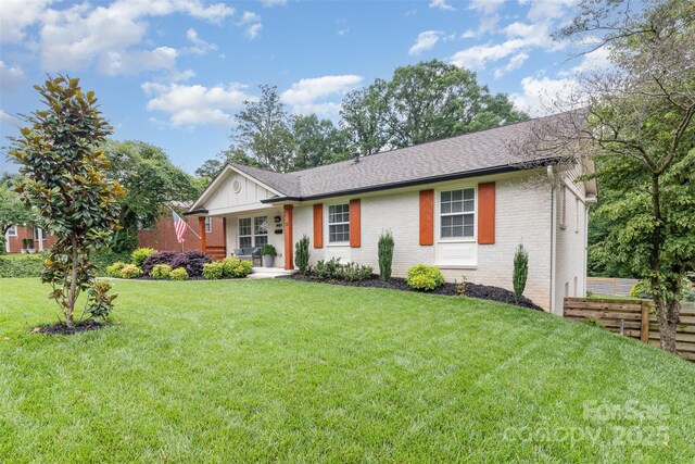 1621 Brookdale Ave, Charlotte, NC 28210 - ranch-style home featuring brick siding, covered porch, a shingled roof, and board and batten siding
