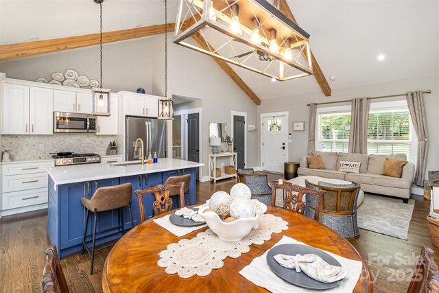 1621 Brookdale Ave, Charlotte, NC 28210 - dining space featuring dark wood finished floors, beamed ceiling, high vaulted ceiling, and a chandelier