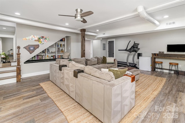 1621 Brookdale Ave, Charlotte, NC 28210 - living area featuring wood finished floors, recessed lighting, ceiling fan, baseboards, and stairs
