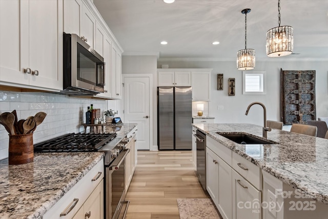 602 Compass Dr, Denver, NC 28037 - kitchen featuring appliances with stainless steel finishes, a sink, crown molding, white cabinetry, and light wood-style flooring