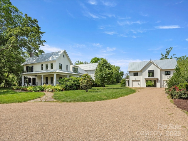 146 Lower Brush Creek Rd, Fletcher, NC 28732 - view of front of property featuring an attached garage, dirt driveway, a front yard, covered porch, and metal roof