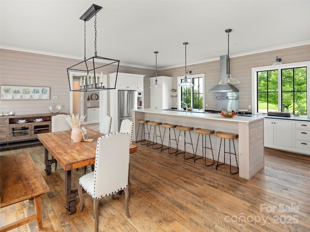 146 Lower Brush Creek Rd, Fletcher, NC 28732 - dining room with wood-type flooring, a chandelier, wooden walls, and crown molding