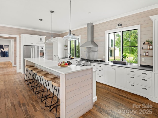 146 Lower Brush Creek Rd, Fletcher, NC 28732 - kitchen featuring wall chimney range hood, stainless steel appliances, dark wood-style flooring, an island with sink, and crown molding