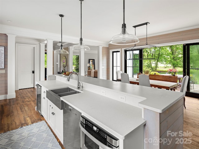 146 Lower Brush Creek Rd, Fletcher, NC 28732 - kitchen featuring a sink, ornate columns, hardwood / wood-style flooring, a center island with sink, and stainless steel appliances