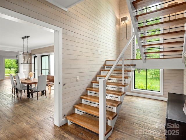 146 Lower Brush Creek Rd, Fletcher, NC 28732 - staircase featuring a chandelier, hardwood / wood-style flooring, wooden walls, and crown molding