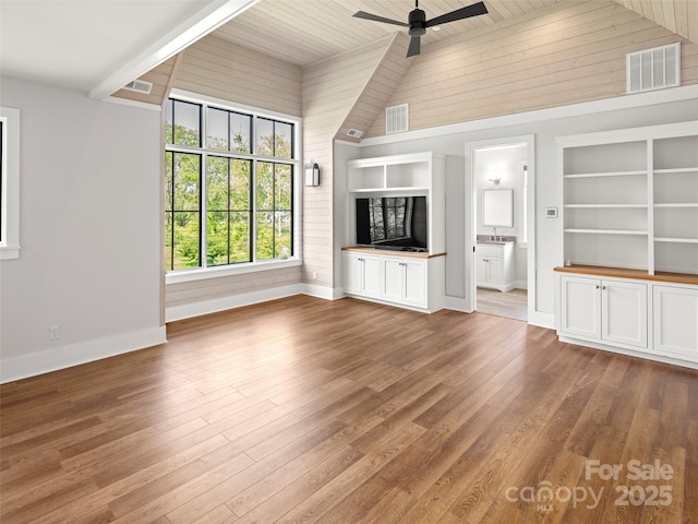146 Lower Brush Creek Rd, Fletcher, NC 28732 - unfurnished living room with a ceiling fan, baseboards, wood-type flooring, built in shelves, and wooden ceiling