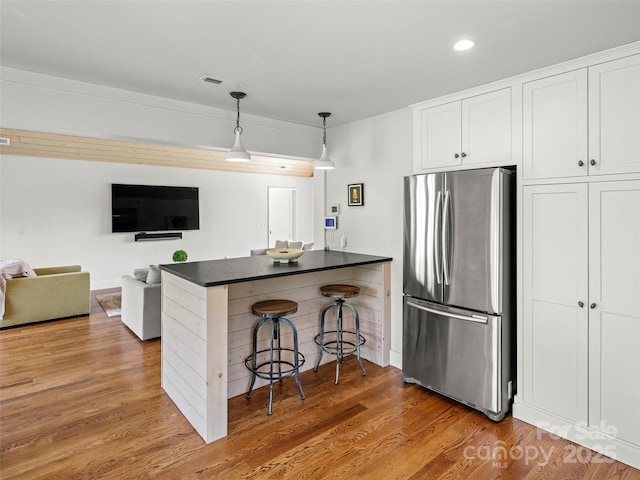 146 Lower Brush Creek Rd, Fletcher, NC 28732 - kitchen featuring freestanding refrigerator, dark countertops, a kitchen breakfast bar, a peninsula, and white cabinets