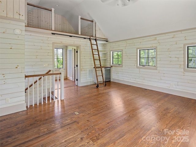 146 Lower Brush Creek Rd, Fletcher, NC 28732 - empty room with plenty of natural light, wood finished floors, and vaulted ceiling