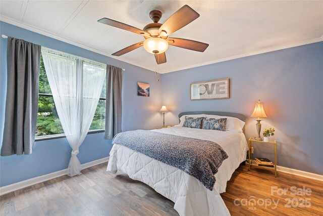 100 Bettys Dr, Waynesville, NC 28786 - bedroom featuring baseboards, ornamental molding, wood finished floors, and a ceiling fan