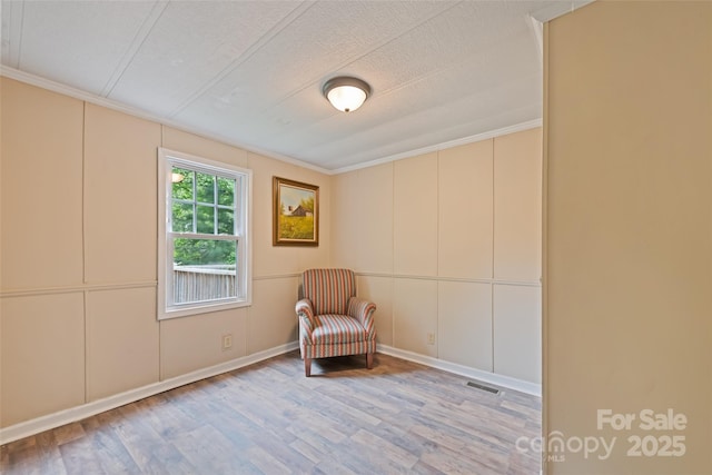 100 Bettys Dr, Waynesville, NC 28786 - living area with wood finished floors, ornamental molding, and a decorative wall