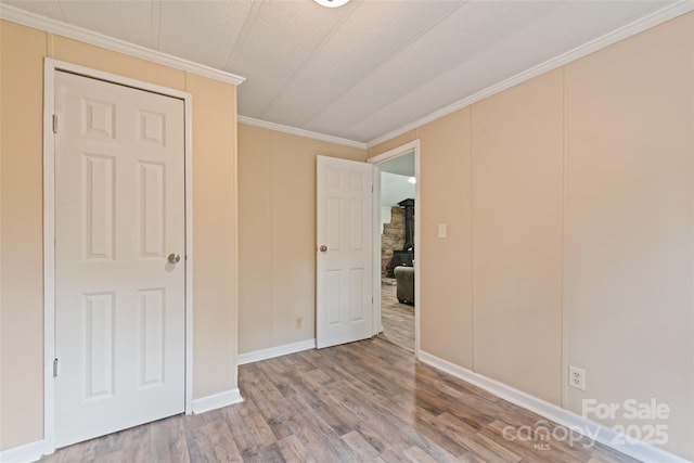 100 Bettys Dr, Waynesville, NC 28786 - unfurnished bedroom with wood finished floors, crown molding, and baseboards