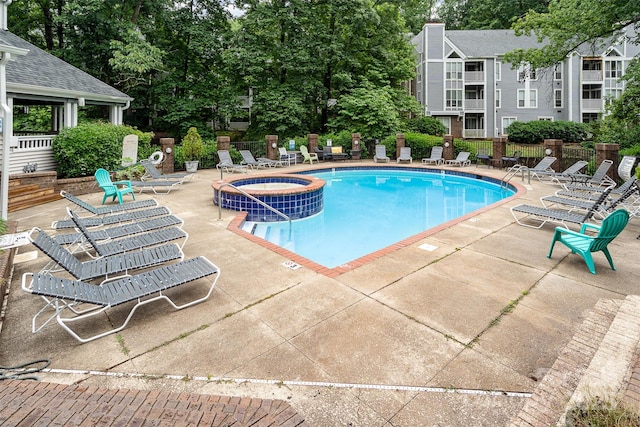 2512 Cranbrook Ln Unit 9, Charlotte, NC 28207 - view of pool with a pool with connected hot tub, a patio, and view of wooded area