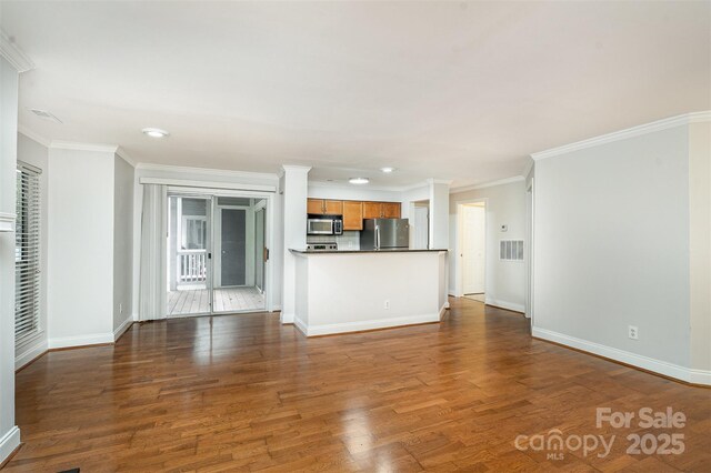 2512 Cranbrook Ln Unit 9, Charlotte, NC 28207 - unfurnished living room featuring baseboards, dark wood-type flooring, crown molding, and recessed lighting