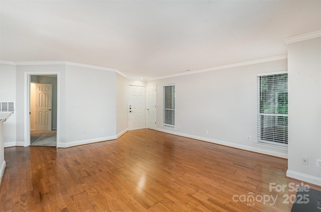 2512 Cranbrook Ln Unit 9, Charlotte, NC 28207 - spare room with light wood-style flooring, baseboards, and crown molding