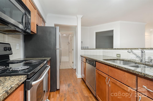 2512 Cranbrook Ln Unit 9, Charlotte, NC 28207 - kitchen featuring electric range oven, dishwasher, brown cabinets, a sink, and decorative backsplash