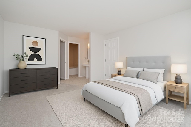 2512 Cranbrook Ln Unit 9, Charlotte, NC 28207 - bedroom with light carpet, baseboards, and connected bathroom
