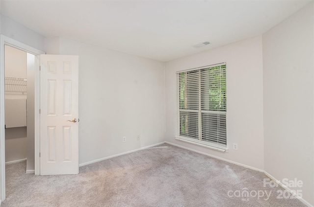 2512 Cranbrook Ln Unit 9, Charlotte, NC 28207 - spare room featuring carpet and baseboards