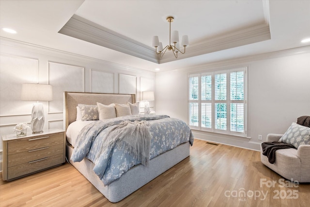 5917 Bridger Ct, Charlotte, NC 28211 - bedroom with crown molding, a raised ceiling, a chandelier, light wood-style floors, and recessed lighting