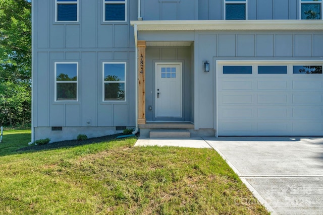 7874 Lucky Creek Ln, Denver, NC 28037 - view of exterior entry with board and batten siding, a lawn, driveway, crawl space, and a garage