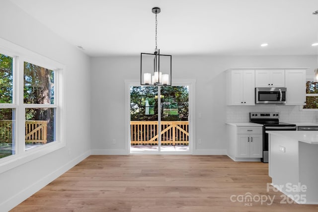 7874 Lucky Creek Ln, Denver, NC 28037 - kitchen with appliances with stainless steel finishes, a chandelier, baseboards, decorative backsplash, and recessed lighting