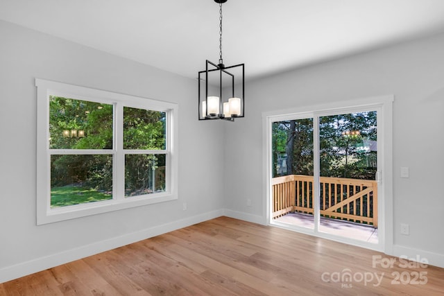 7874 Lucky Creek Ln, Denver, NC 28037 - unfurnished dining area with plenty of natural light, a chandelier, baseboards, and wood finished floors