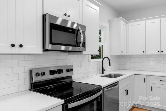 7874 Lucky Creek Ln, Denver, NC 28037 - kitchen featuring appliances with stainless steel finishes, a sink, white cabinetry, and backsplash