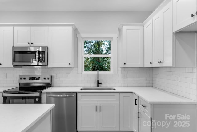 7874 Lucky Creek Ln, Denver, NC 28037 - kitchen with appliances with stainless steel finishes, a sink, white cabinetry, decorative backsplash, and light stone counters