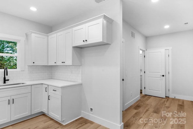 7874 Lucky Creek Ln, Denver, NC 28037 - kitchen featuring a sink, light wood finished floors, backsplash, recessed lighting, and white cabinets