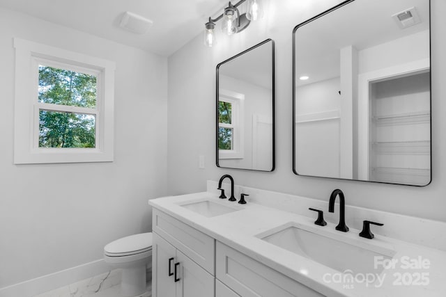 7874 Lucky Creek Ln, Denver, NC 28037 - bathroom with marble look tiles, healthy amount of natural light, baseboards, and double vanity