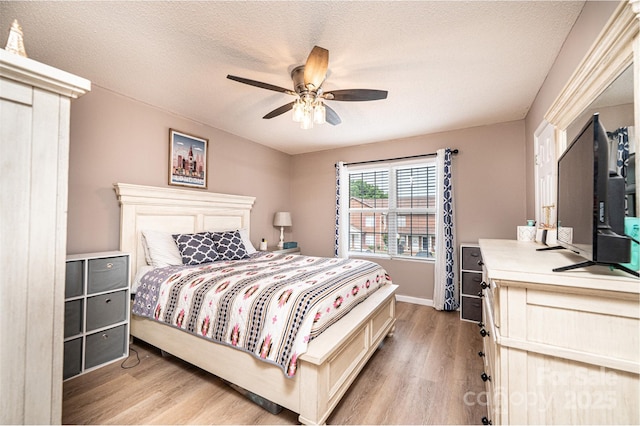 102 Brandywine Dr NE Unit O-3, Conover, NC 28613 - bedroom with light wood-style floors, baseboards, a textured ceiling, and ceiling fan