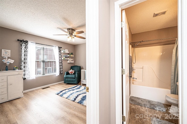 102 Brandywine Dr NE Unit O-3, Conover, NC 28613 - full bath featuring wood finished floors, ceiling fan, toilet, shower / tub combination, and a textured ceiling