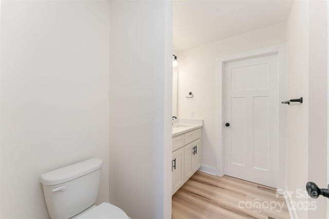 406 N Bostian St, China Grove, NC 28023 - bathroom featuring vanity, toilet, and wood finished floors