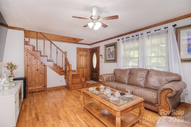 109 Larch Rd, Salisbury, NC 28147 - living area with stairs, light wood-style floors, ceiling fan, a textured ceiling, and ornamental molding