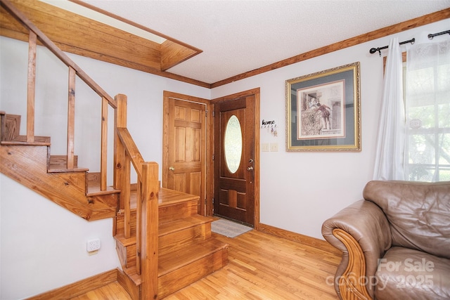 109 Larch Rd, Salisbury, NC 28147 - entryway featuring stairs, wood finished floors, a textured ceiling, and ornamental molding