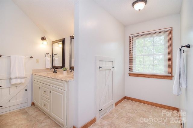 109 Larch Rd, Salisbury, NC 28147 - full bathroom featuring vaulted ceiling, double vanity, and tile patterned floors