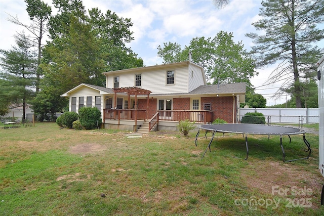 109 Larch Rd, Salisbury, NC 28147 - rear view of house featuring a pergola, a wooden deck, a trampoline, and brick siding