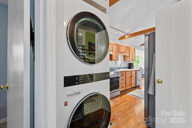 1672 Memorial Hwy, Lake Lure, NC 28746 - laundry room featuring stacked washer / drying machine and light wood-style floors