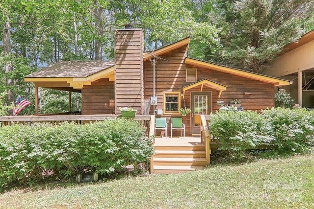 46 Thrush Dr, Maggie Valley, NC 28751 - back of house featuring a wooden deck, a chimney, and a lawn