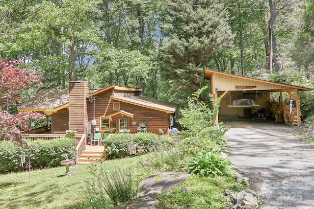 46 Thrush Dr, Maggie Valley, NC 28751 - view of front of house featuring a chimney, driveway, and a wooden deck
