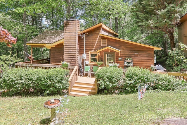 46 Thrush Dr, Maggie Valley, NC 28751 - view of front facade with a chimney, a wooden deck, and a front yard