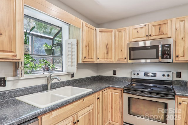 46 Thrush Dr, Maggie Valley, NC 28751 - kitchen with appliances with stainless steel finishes, a sink, light brown cabinets, and dark countertops