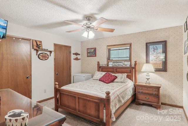 46 Thrush Dr, Maggie Valley, NC 28751 - bedroom with light carpet, baseboards, a ceiling fan, a textured ceiling, and two closets