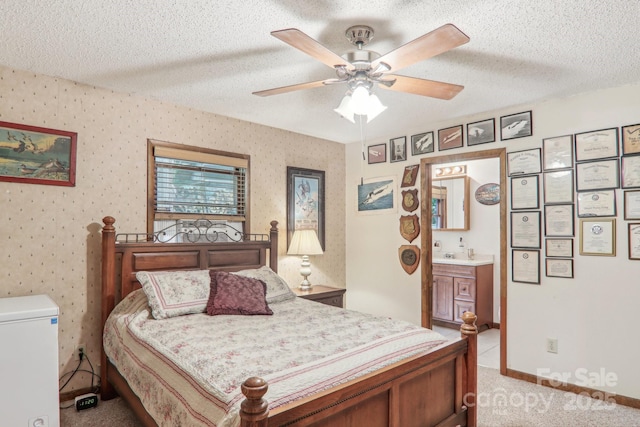 46 Thrush Dr, Maggie Valley, NC 28751 - bedroom featuring light colored carpet, a textured ceiling, connected bathroom, and a ceiling fan