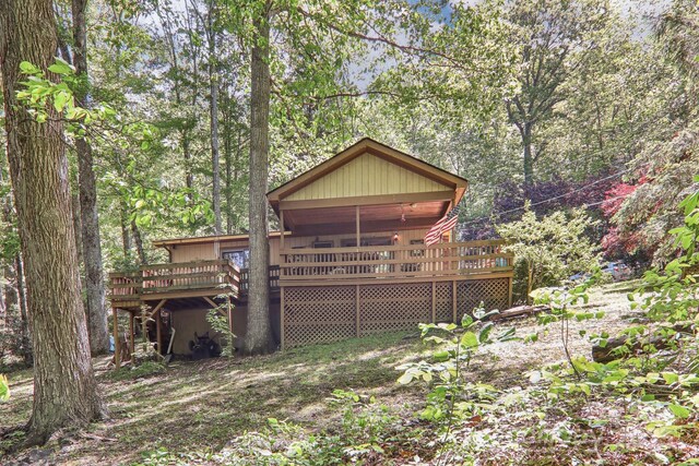 46 Thrush Dr, Maggie Valley, NC 28751 - rear view of property featuring a wooden deck and a wooded view