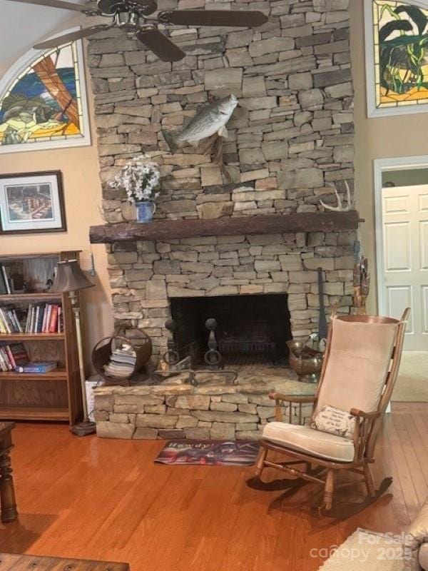 240 Goshen Ter, Wilkesboro, NC 28697 - living area with a stone fireplace, ceiling fan, and wood finished floors