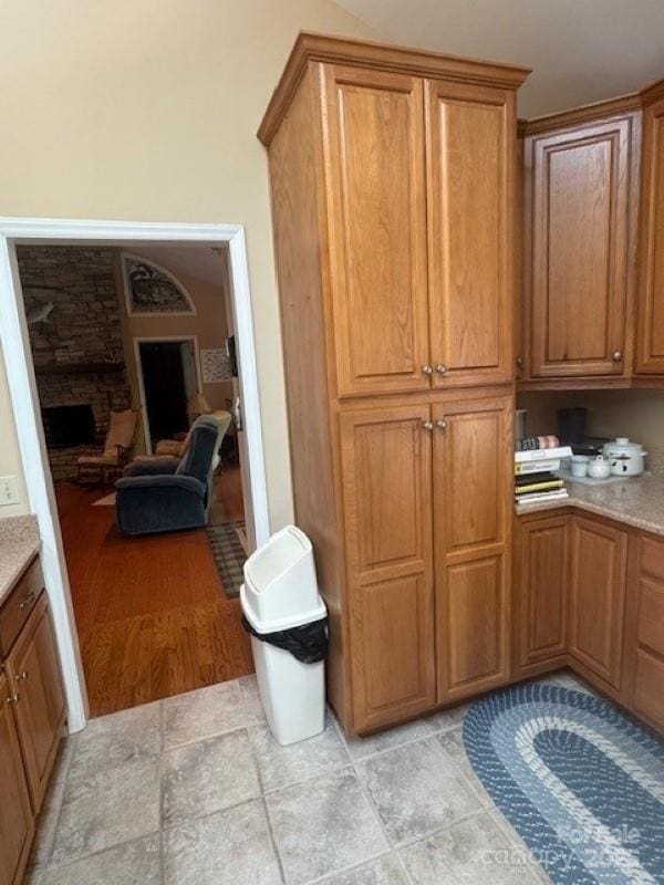 240 Goshen Ter, Wilkesboro, NC 28697 - kitchen featuring brown cabinetry and a stone fireplace