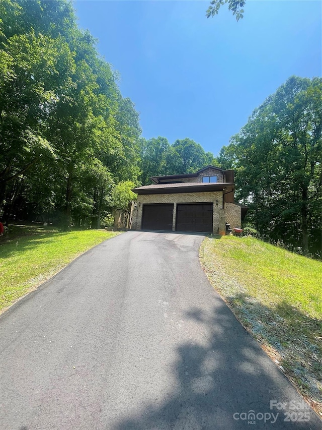 2505 White Thorne Ln, Waxhaw, NC 28173 - view of front facade with driveway, a garage, a front lawn, and brick siding
