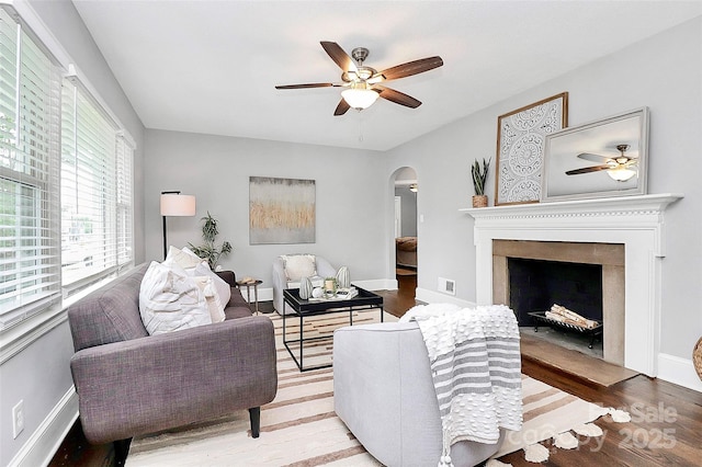 2421 Shamrock Dr, Charlotte, NC 28205 - living area featuring ceiling fan, arched walkways, and wood finished floors