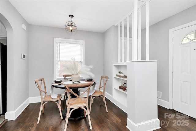 2421 Shamrock Dr, Charlotte, NC 28205 - dining space featuring arched walkways, wood finished floors, built in features, and baseboards